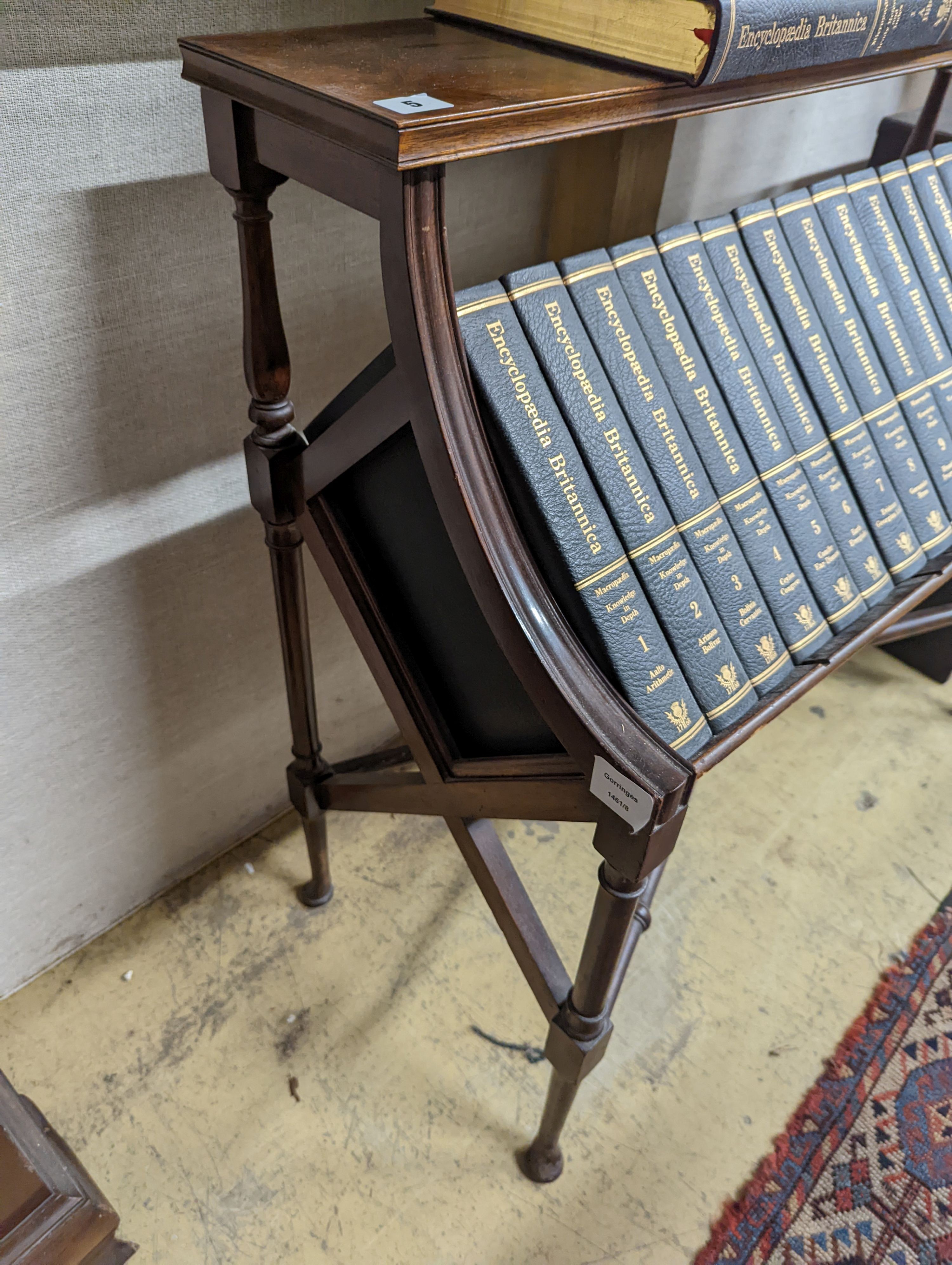 A Liberty style mahogany book stand, together with a set of the Encyclopedia Britannica, width 91cm, depth 39cm, height 84cm